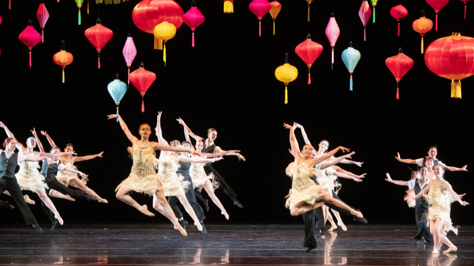 ballet dancers on stage with lanterns overhead