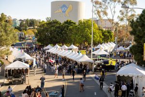Aerial view of the tents on Mesa Road with the Anteater water tower in the background